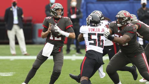 Tampa Bay Buccaneers quarterback Tom Brady (12) looks to pass against the rush of Atlanta Falcons defensive end Danter Fowler during the first half Sunday, Jan. 3, 2021, in Tampa, Fla. (Mark LoMoglio/AP)