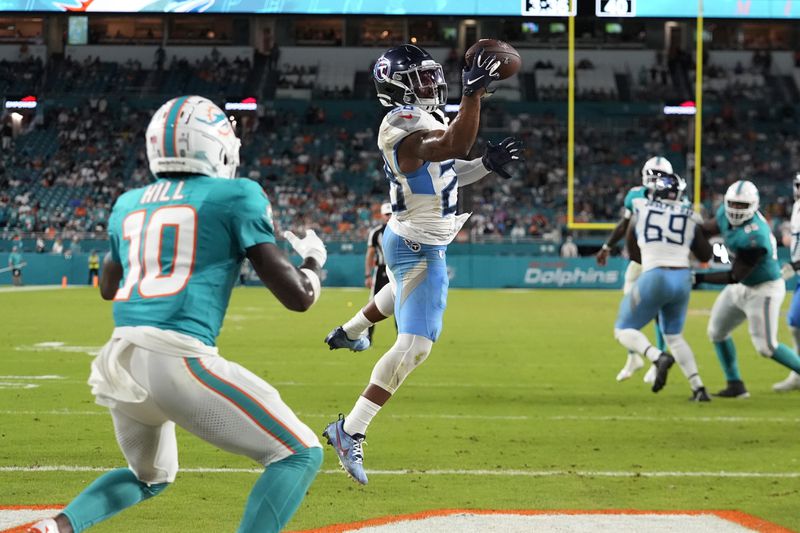 Tennessee Titans safety Quandre Diggs (28) intercepts a pass in the endzone intended for Miami Dolphins wide receiver Tyreek Hill (10) during the second half of an NFL football game, Monday, Sept. 30, 2024, in Miami Gardens, Fla. (AP Photo/Rebecca Blackwell)