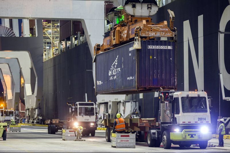 FILE - Ship to shore cranes and gangs of longshoremen work the container ship YM Witness at the Georgia Ports Authority's Port of Savannah, Sept. 29, 2021, in Savannah, Ga. (AP Photo/Stephen B. Morton, File)