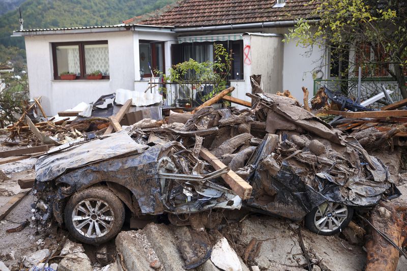 A damaged car is seen after flood hit the village of Donja Jablanica, Bosnia, Saturday, Oct. 5, 2024. (AP Photo/Armin Durgut)