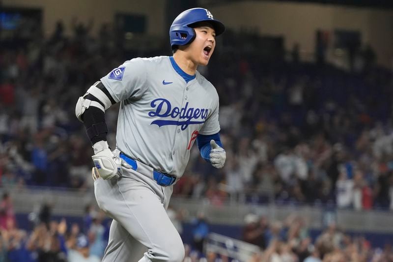 Los Angeles Dodgers' Shohei Ohtani (17) reacts after hitting his 50th home run of the season during the seventh inning of a baseball game against the Miami Marlins, Thursday, Sept. 19, 2024, in Miami. (AP Photo/Marta Lavandier)