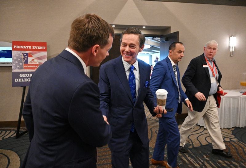 Guest speaker Ralph Reed, founder of the Faith and Freedom Coalition, is greeted by a guest during a breakfast gathering with the Georgia delegation in Delavan, Wis.