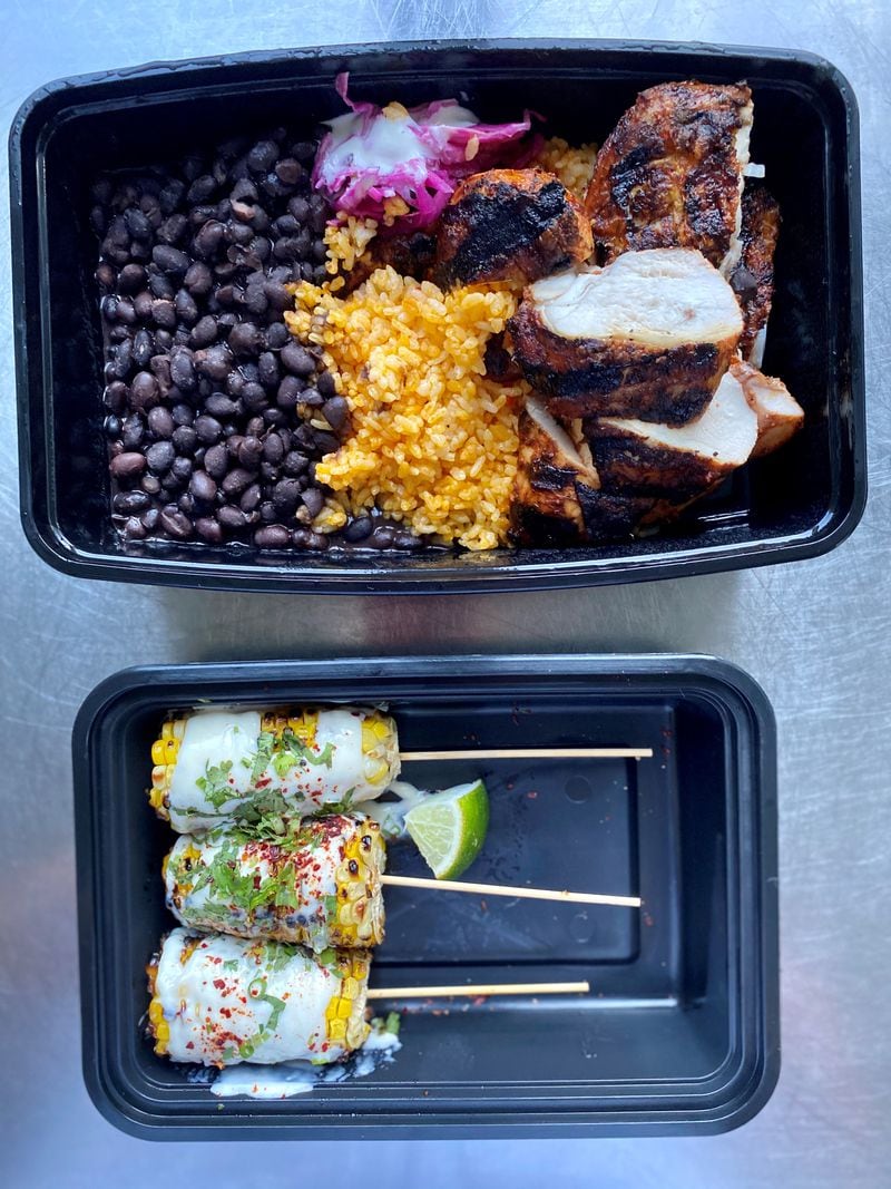 This takeout order from Bar Mercado includes: Peruvian-spiced grilled chicken, with rice, beans and Salvadoran slaw; and Mexican street corn. Wendell Brock for The AJC