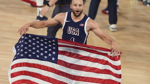 The United States had a big day at the Paris Olympics Saturday, winning gold medals in basketball, soccer and track, plus medals in other sports. Take a look at the celebration, starting with Stephen Curry rejoicing after leading the U.S. past France in basketball for the gold. (AP Photo/Michael Conroy)