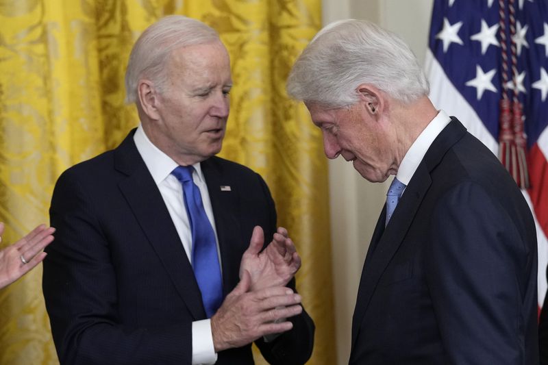 FILE - President Joe Biden talks with former President Bill Clinton during an event in the East Room of the White House in Washington, Feb. 2, 2023. Biden is again joining forces with former President Bill Clinton to rake in campaign cash, with a joint fundraiser with the two men Tuesday set to raise $8 million — part of a $40 million total that Biden's reelection campaign has pulled in over the last five days. (AP Photo/Susan Walsh, File)