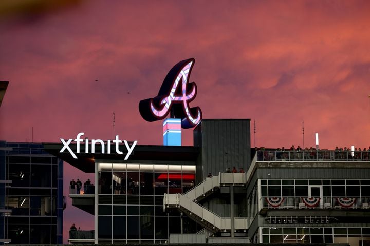 The sun sets after a rain delay during game two of the National League Division Series baseball game between the Braves and the Phillies at Truist Park in Atlanta on Wednesday, October 12, 2022. (Jason Getz / Jason.Getz@ajc.com)