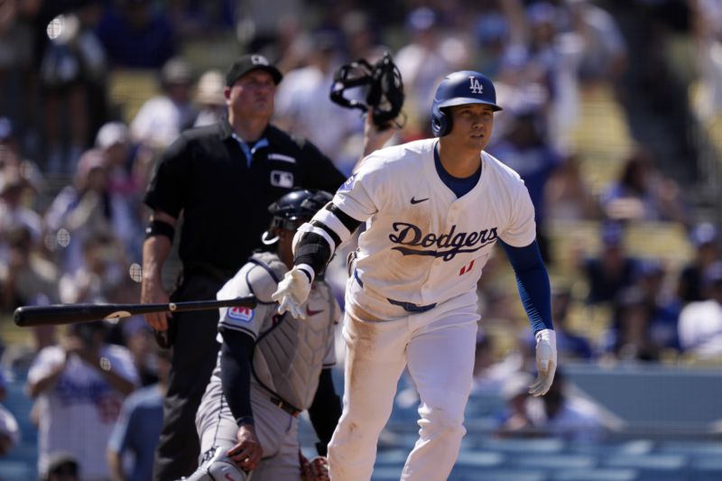 Los Angeles Dodgers' Shohei Ohtani, right, heads to first for a solo home run as Cleveland Guardians catcher Bo Naylor, center, and home plate umpire Dan Bellino watch during the fifth inning of a baseball game, Sunday, Sept. 8, 2024, in Los Angeles. (AP Photo/Mark J. Terrill)