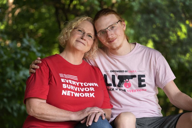 Denise Wieck and her son Guy Boyd,who was shot in the eye with a ghost gun, pose in Ypsilanti, Mich., Saturday, Sept. 14, 2024. (AP Photo/Paul Sancya)