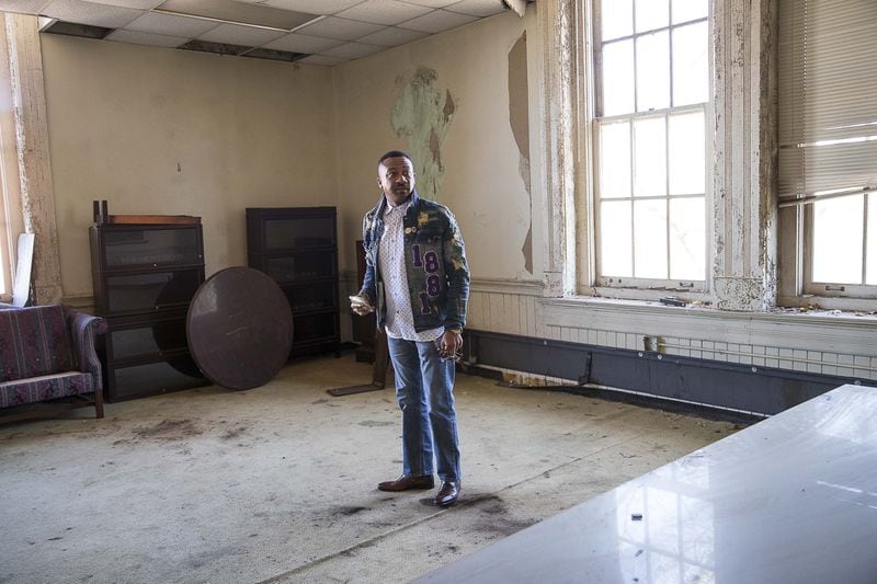 Acting President of Morris Brown College, Kevin James, surveys an abandoned classroom at Fountain Hall on the campus of Morris Brown College, Thursday, December 5, 2019. The room that James is standing in is said to be the same room where W.E.B. Du Bois wrote “The Souls of Black Folks.” (ALYSSA POINTER/ALYSSA.POINTER@AJC.COM)