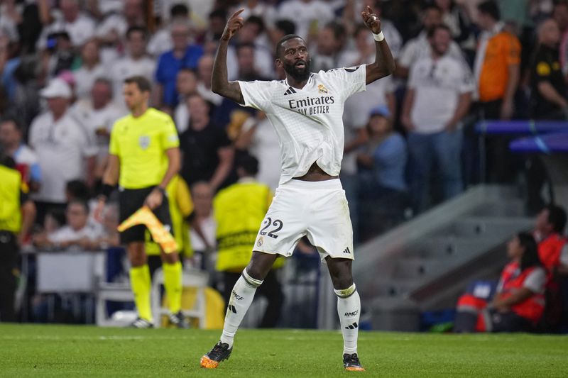 Real Madrid's Antonio Rudiger celebrates after scoring his side's second goal during the Champions League opening phase soccer match between Real Madrid and VfB Stuttgart at the Santiago Bernabeu stadium, in Madrid, Tuesday, Sept. 17, 2024. (AP Photo/Manu Fernandez)