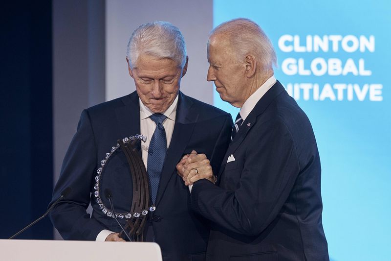 Bill Clinton, founder and board chair of the Clinton Foundation & 42nd President of the United States, left, gives President Joe Biden the "Global Citizen Award" as they clasp hands during the Clinton Global Initiative, on Monday, Sept. 23, 2024, in New York. (AP Photo/Andres Kudacki)