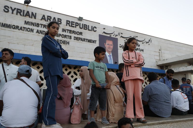 Syrians fleeing the war in Lebanon, arrive at the Syrian-Lebanese border crossing in Jdeidet Yabous, Syria, Wednesday, Sept. 25, 2024. (AP Photo/Omar Sanadiki)