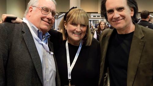 FILE - The children of Berkshire Hathaway Chairman and CEO Warren Buffett, from left, Howard Buffett, Susie Buffett, and Peter Buffett, pose for a photo at the CenturyLink Center exhibit hall in Omaha, Neb., May 1, 2015. (AP Photo/Nati Harnik, File)