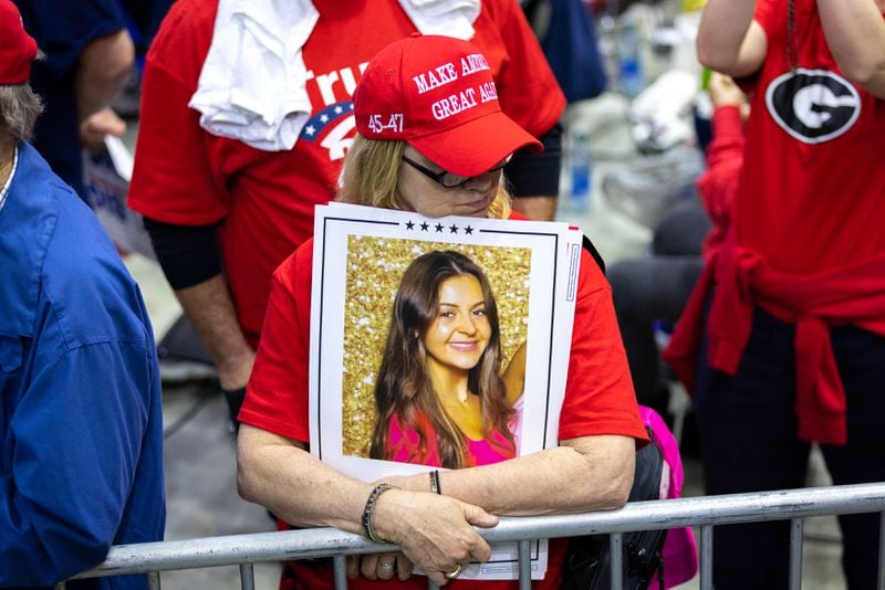 A Donald Trump supporter holds a sign with a photo of slain nursing student Laken Riley at a Trump rally in Rome on March 9. Riley's death sparked national debate about immigration, as suspect Jose Ibarra entered the United States illegally, according to federal authorities. (Arvin Temkar / arvin.temkar@ajc.com)