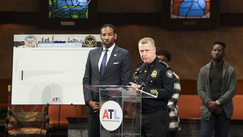 Atlanta Police Department Chief Darin Schierbaum, right, speaks to members of the media during a press conference Thursday to discuss reduced crime rate at Salem Bible Church as Mayor Andre Dickens listens. (Jason Getz / Jason.Getz@ajc.com)