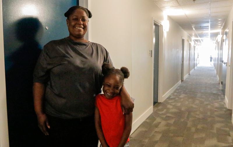 April Bryant stands with her daughter Journee Bryant, 6, at the Studio 6 they are living at in Duluth on Thursday, Aug. 12, 2021. (Christine Tannous / christine.tannous@ajc.com)