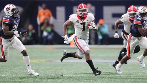 Georgia running back D’Andre Swift breaks away for a long touchdown run against Auburn during the second half of the SEC Football Championship at Mercedes-Benz Stadium, December 2, 2017, in Atlanta.  Curtis Compton / ccompton@ajc.com