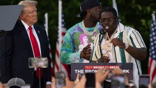 Rappers Sheff G, right, also known as Michael Williams, and Sleepy Hallow, center, also known as Tegan Chambers, join the Republican presidential candidate former President Donald Trump during a campaign rally in the south Bronx, Thursday, May. 23, 2024, in New York. (AP Photo/Yuki Iwamura)