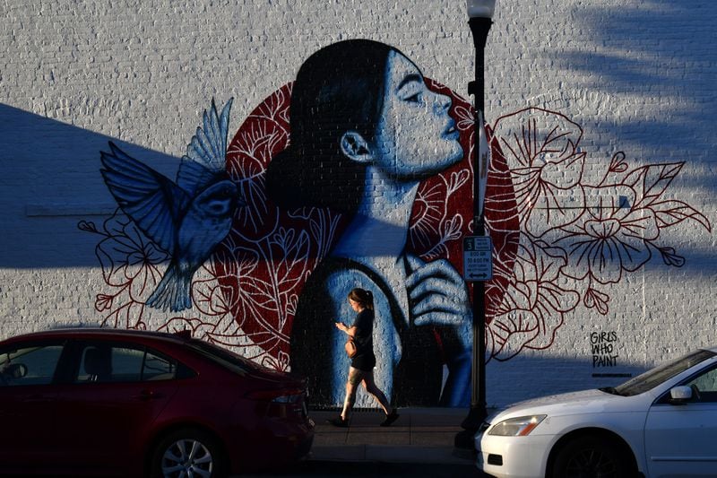 A mural on Poplar Street in downtown Macon, an avenue that has been a focal point of revival in this two-century-old city. (Hyosub Shin / AJC)