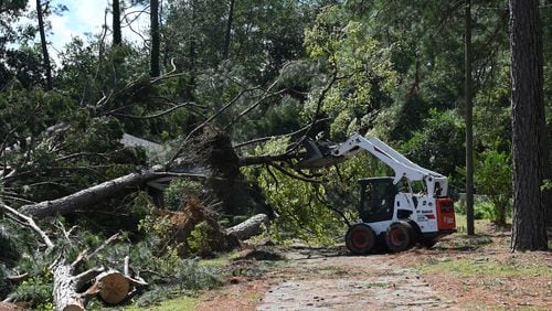 Crew cleans up fallen trees, where a man was killed by fallen trees caused by Hurricane Helene, Friday, September 27, 2024 in Dublin. Fast-moving Helene, which entered Georgia as a Category 2 hurricane Friday morning, continues its powerful march toward metro Atlanta. The storm, which made landfall as a Category 4 in Florida’s Big Bend region Thursday night with maximum sustained winds of 140 mph, continues to pack a dangerous punch and is responsible for at least three deaths in Georgia. Helene’s sustained winds are now at 70 mph, making it a tropical storm status, and it is quickly traveling north. (Hyosub Shin / AJC)