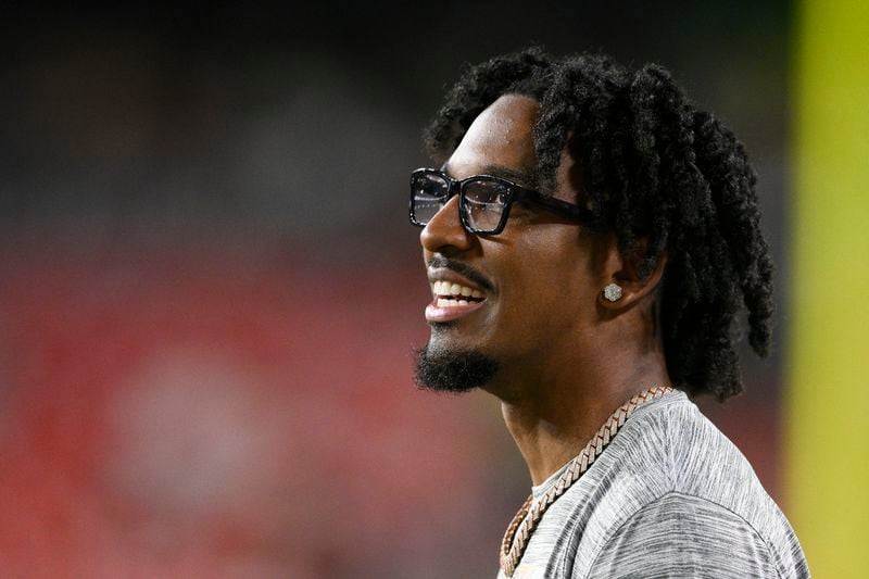 Washington Commanders quarterback Jayden Daniels watches from the sideline during the first half of a preseason NFL football game against the New England Patriots, Sunday, Aug. 25, 2024, in Landover, Md. (AP Photo/Nick Wass)