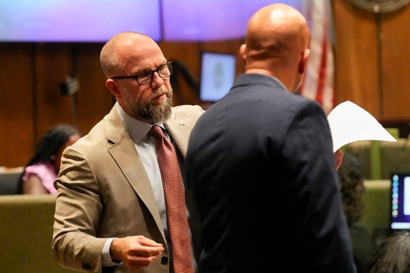 Defendant Justin Johnson's attorney Luke Evans, left, speaks with Paul Hagerman, Shelby County deputy district attorney, right, during Johnson's trial for the murder of rapper Young Dolph, Tuesday, Sept. 24, 2024, in Memphis, Tenn. (AP Photo/George Walker IV, Pool)