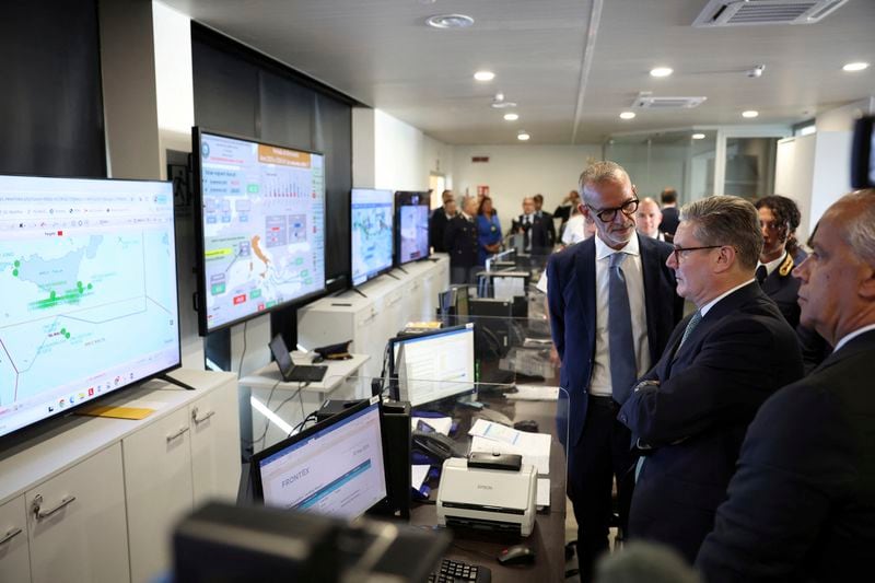 British Prime Minister Keir Starmer looks at screens showing the maritime traffic off the Italian coast during his visit to Italy’s national immigration crime coordination center, in Rome, Monday, Sept. 16, 2024. (Phil Noble/Pool Photo via AP)