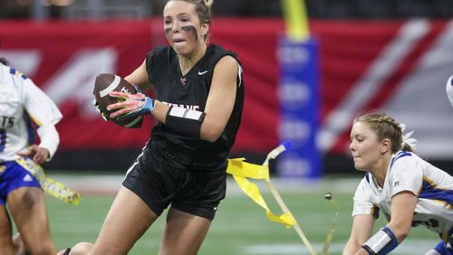 North Oconee wide receiver Grace Maddox (32) has her flag pulled by SE Bulloch defensive back Ava King (10) during the Girl’s Flag Football A-4A GHSA State Championship game at Mercedes-Benz Stadium, Monday, December. 11, 2023, in Atlanta. SE Bulloch won 14-0. (Jason Getz / Jason.Getz@ajc.com)