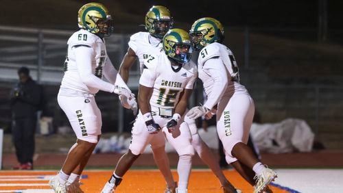 Grayson running back David Moncrief (12) celebrates a rushing touchdown with teammates against Parkview in the first half  at Parkview High School, Friday, November 3, 2023, in Lilburn, Ga. (Jason Getz / Jason.Getz@ajc.com)