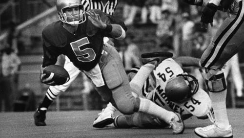Notre Dame quarterback Mike Courey is sacked by Georgia Tech's Steve Mooney (54) in the fourth quarter of Saturday's game. Nov. 8, 1980. (Billy Downs/AJC staff)