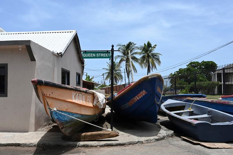 Fishing boats lie in the middle of the street for protection from Hurricane Beryl in Kingston, Jamaica, Tuesday, July 2, 2024. (AP Photo/Collin Reid)