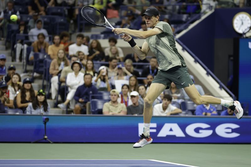 Jannik Sinner, of Italy, returns a shot to Tommy Paul, of the United States, during a fourth round match of the U.S. Open tennis championships, Monday, Sept. 2, 2024, in New York. (AP Photo/Adam Hunger)