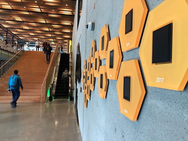 A display of Amazon Kindle e-readers line the wall in the lobby of an Amazon headquarters office in April 2017. (Scott Trubey / Scott.Trubey@ajc.com)