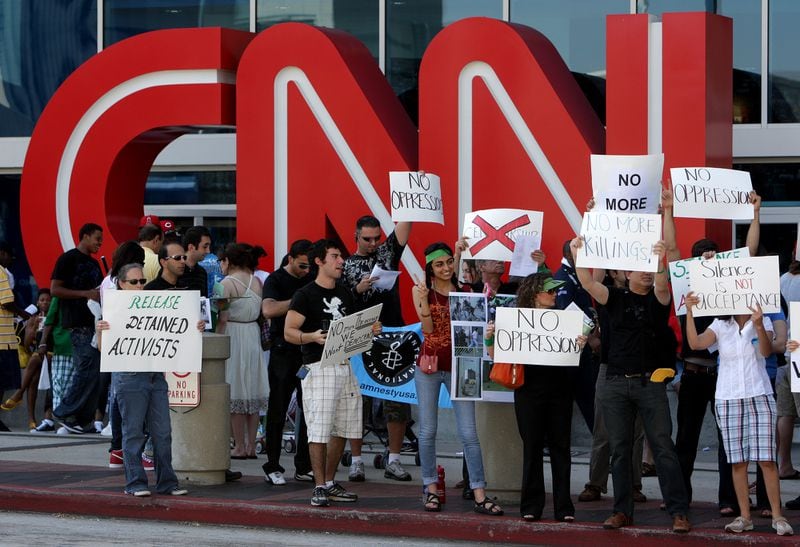 Protesters of the government of Iran carried signs outside CNN Center in June 2009. Johnny Crawford/ AJC 