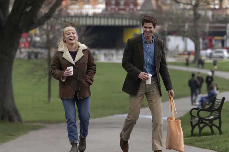 This image released by A24 shows Florence Pugh, left, and Andrew Garfield in a scene from "We Live In Time." (A24 via AP)