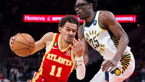 Atlanta Hawks guard Trae Young drives past Indiana Pacers forward Jalen Smith during the first half of an NBA basketball game, Saturday, March 25, 2023, in Atlanta. (AP Photo/Hakim Wright Sr.)
