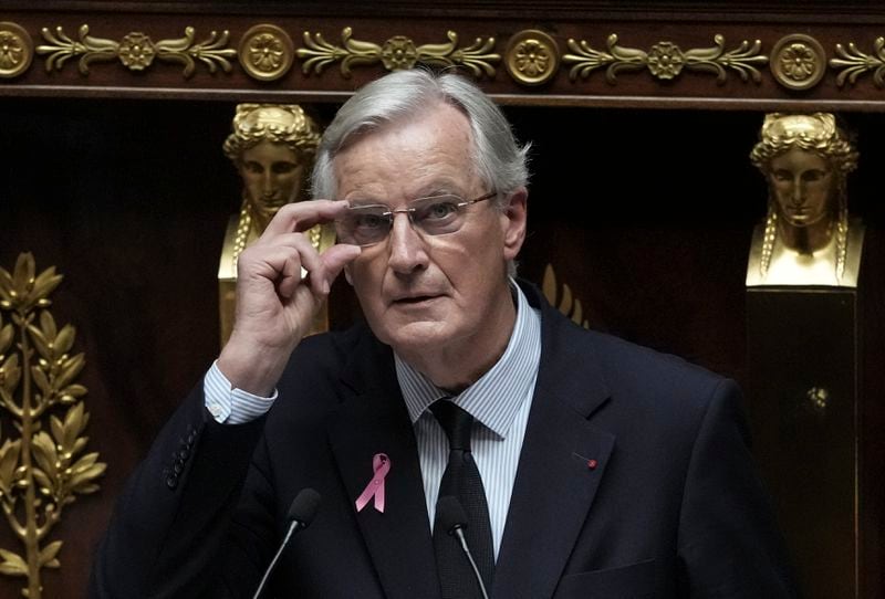 France's Prime Minister Michel Barnier adjusts his glasses as he delivers a speech at the National Assembly, in Paris, Tuesday, Oct. 1, 2024. (AP Photo/Thibault Camus)