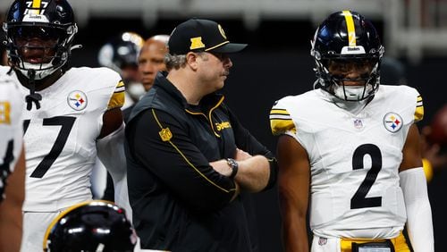 Arthur Smith, Pittsburgh Steelers oﬀensive coordinator and the former Atlanta Falcons head coach, talks with Pittsburgh Steelers quarterback Justin Fields (2) before an NFL football game against the Falcons on Sunday, Sept. 8, 2024, in Atlanta. (AP Photo/Butch Dill)