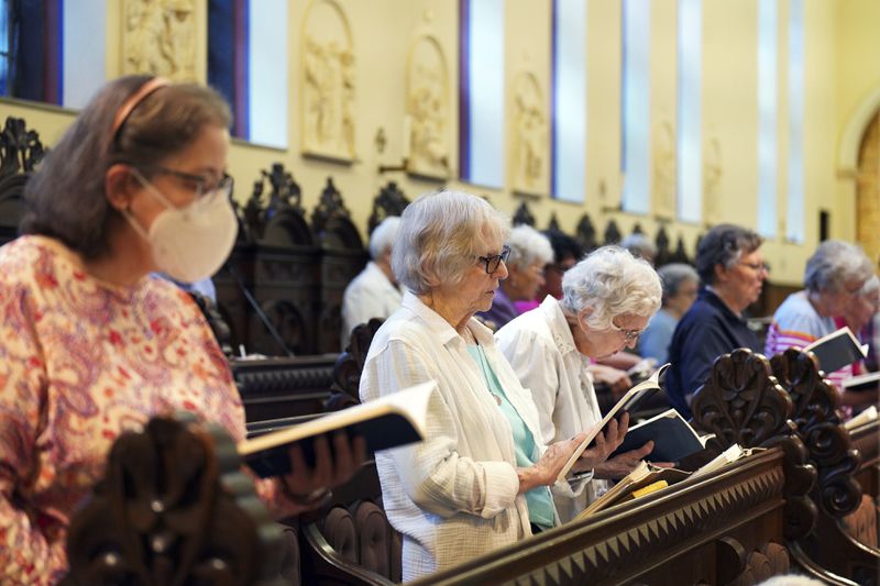 Benedictine sisters join in song during evening prayer at the Mount St. Scholastica monastery in Atchison, Kan., Tuesday, July 16, 2024. (AP Photo/Jessie Wardarski)