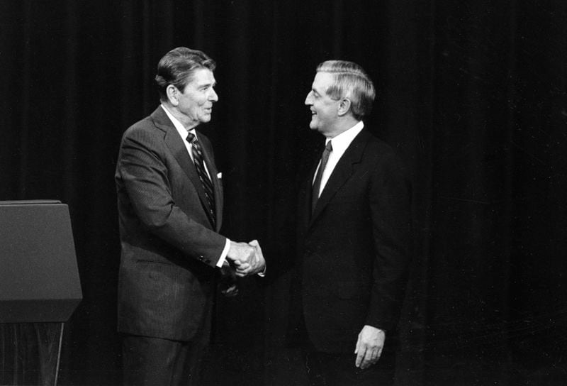 FILE - President Ronald Reagan, left, and his Democratic challenger Walter Mondale, shake hands before debating in Kansas City, Mo., Oct. 22, 1984. (AP Photo/Ron Edmonds, File)