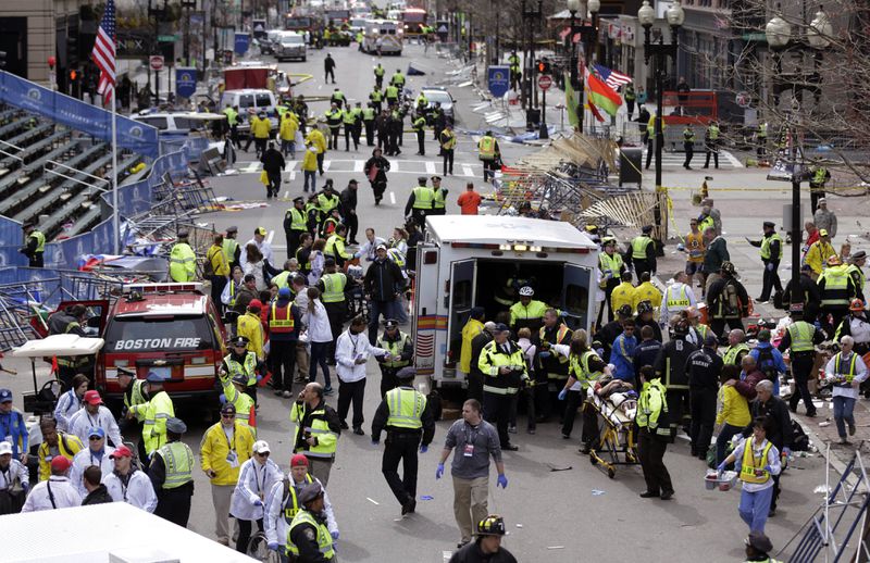 FILE - Medical workers aid injured people following an explosion at the finish line of the 2013 Boston Marathon in Boston, April 15, 2013. (AP Photo/Charles Krupa, File)