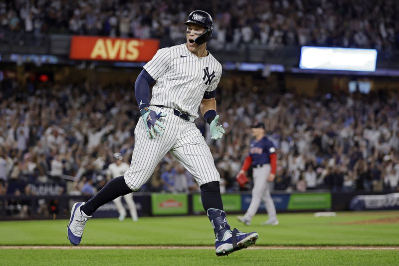 New York Yankees' Aaron Judge reacts after hitting a grand slam off Boston Red Sox relief pitcher Cam Booser during the seventh inning of a baseball game Friday, Sept. 13, 2024, in New York. (AP Photo/Adam Hunger)