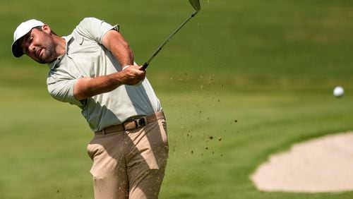 Scottie Scheffler hits from the first fairway during the final round of the Tour Championship golf tournament, Sunday, Sept. 1, 2024, in Atlanta. (AP Photo/Mike Stewart)