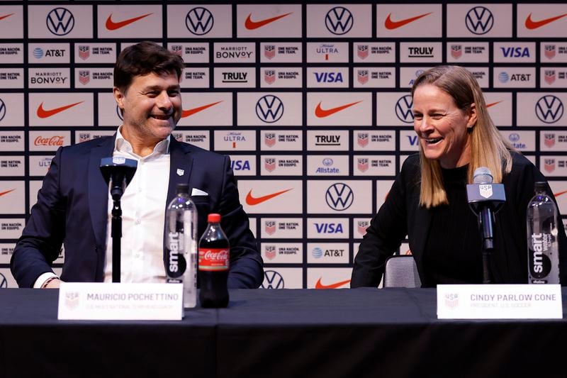 Mauricio Pochettino, left, the newly appointed head coach of the United States men's national soccer team, and U.S. Soccer Federation President Cindy Parlow Cone laugh during a press conference Friday, Sept. 13, 2024, in New York. (AP Photo/Adam Hunger)