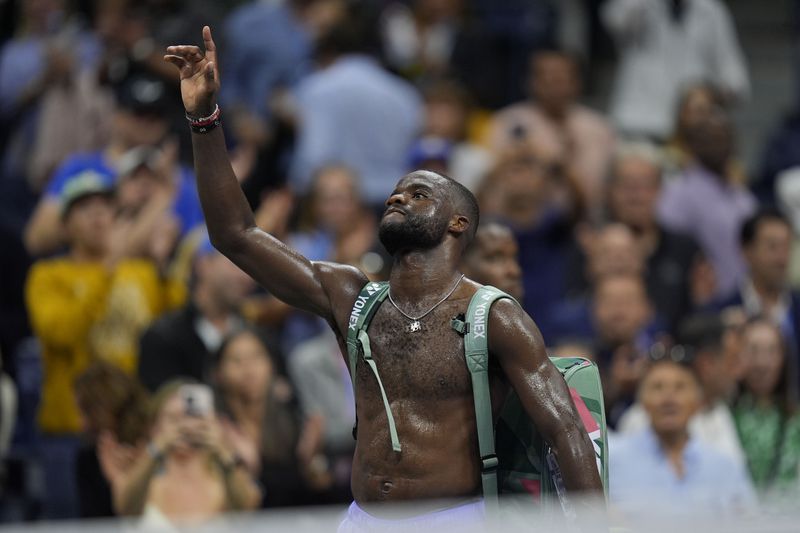 Frances Tiafoe, of the United States, waves to fans after being defeated by Taylor Fritz, of the United States, during the men's singles semifinals of the U.S. Open tennis championships, Friday, Sept. 6, 2024, in New York. (AP Photo/Seth Wenig)