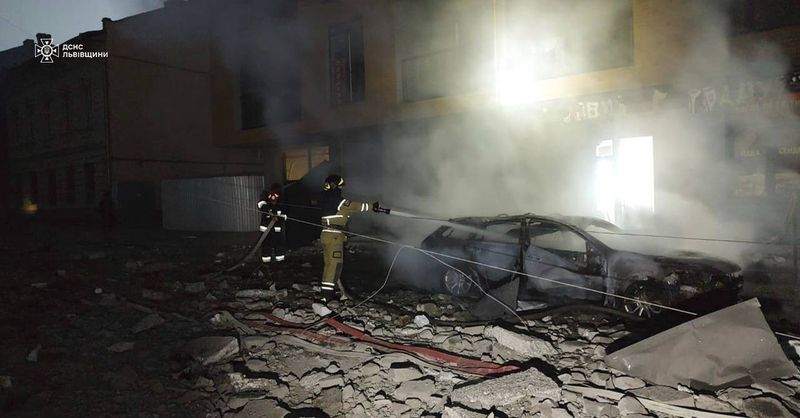 In this photo provided by the State Emergency Service of Ukraine on September 4, 2024, a rescue worker extinguishes a car destroyed by a Russian strike in Lviv, Ukraine. (State Emergency Service of Ukraine via AP)