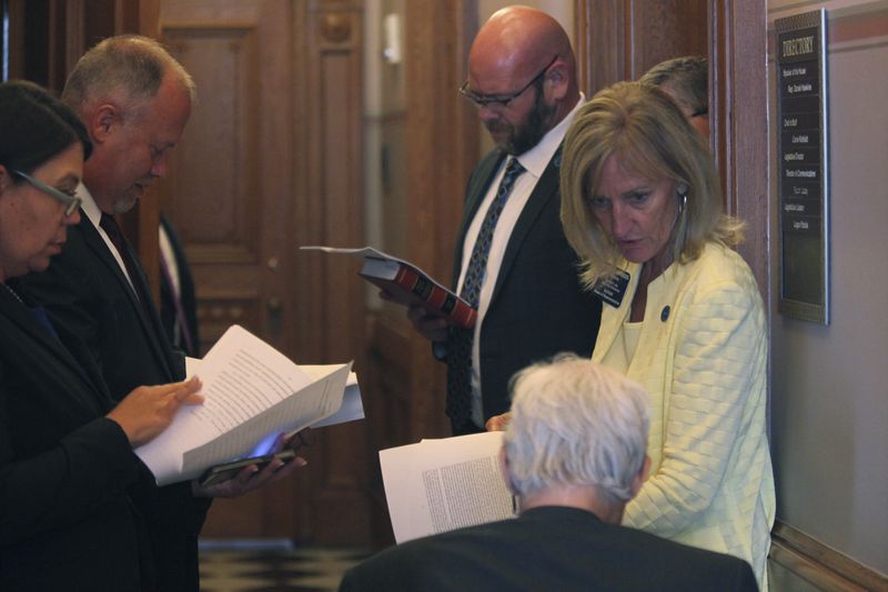 Members of the Kansas House Rules Committee, led by Rep. Susan Humphries, at the far right, R-Wichita, reviews a proposed amendment to the bill aimed at luring the Kansas City Chiefs from Missouri and concludes that it is out of order, Tuesday, June 18, 2024, at the Statehouse in Topeka, Kansas. The measure would allow the state to issue bonds to help the Super Bowl champion Chiefs and Major League Baseball's Kansas City Royals finance new stadiums in Kansas. (AP Photo/John Hanna)