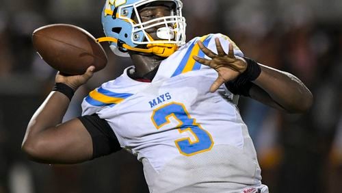 Mays quarterback Quintavious Johnson (3) shown here at the 2021 Corky Kell Classic football game at West Forsyth High School, is a University of Georgia commit as a defensive lineman. He still occasionally plays quarterback and is hard to bring down. (Daniel Varnado/ For the AJC)