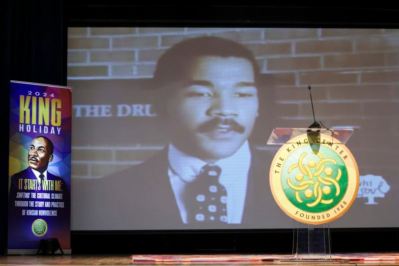 A video plays with the image of Dexter Scott King before the King family hold a press conference on the passing of, Dexter Scott King, son of Dr. Martin Luther King, Jr. at the Yolanda D. King Theatre for the Performing Arts, Tuesday, January 23, 2024. (Jason Getz/jason.getz@ajc.com)