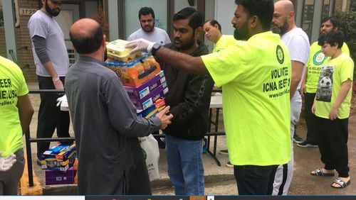 Volunteers at the Islamic Circle of North America pack boxes of food for those in need, including senior citizens, people with compromised immune systems and children who are out of school. CONTRIBUTED